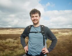 A hiker with a backpack in a field